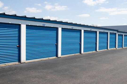 Rows of blue roll-up self storage unit doors at Lost Pines Smart Storage